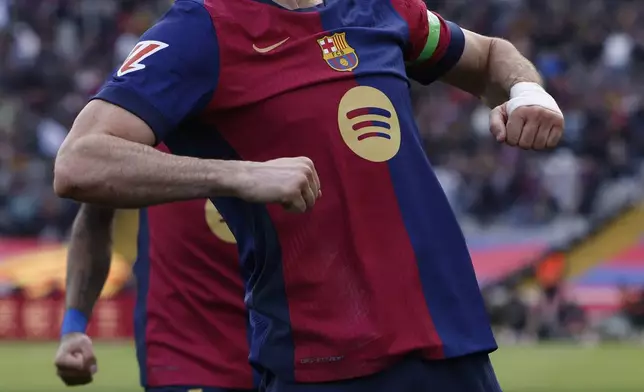 Barcelona's Robert Lewandowski celebrates after scoring the opening goal during a Spanish La Liga soccer match between Barcelona and Alaves at the Lluis Companys Olympic Stadium in Barcelona, Spain, Sunday Feb. 2, 2025. (AP Photo/Joan Monfort)