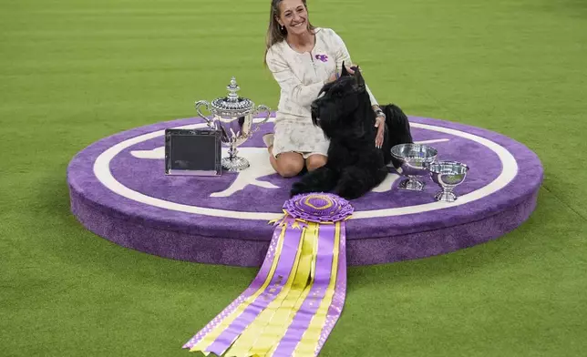 Katie Bernardin and Monty, a Giant Schnauzer, celebrate after winning best in show in the 149th Westminster Kennel Club Dog show, Tuesday, Feb. 11, 2025, in New York. (AP Photo/Julia Demaree Nikhinson)
