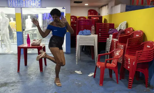 Transgender woman Vanessa Alves, 60, practices before the start of a samba class for the Carnival parade at the Paraiso de Tuiuti samba school in Rio de Janeiro, Wednesday, Feb. 5, 2025. (AP Photo/Silvia Izquierdo)