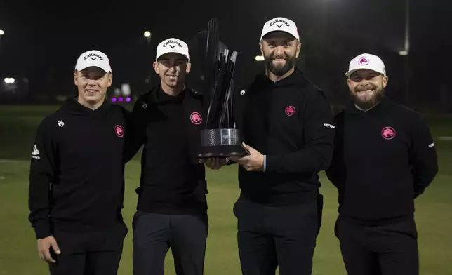 First place team champions Caleb Surratt of Legion XIII, Tom McKibbin of Legion XIII, Captain Jon Rahm of Legion XIII and Tyrrell Hatton of Legion XIII pose with the trophy on the 18th green after the final round of the LIV Golf tournament at Riyadh Golf Club, Saturday, Feb. 8, 2025 in Riyadh, Saudi Arabia. (Photo by Montana Pritchard/LIV Golf via AP)