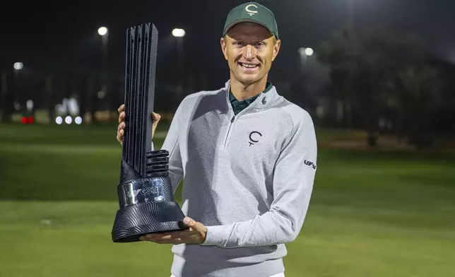 First place individual champion Adrian Meronk of Cleeks GC poses with the trophy on the 18th green after the final round of the LIV Golf tournament at Riyadh Golf Club, Saturday, Feb. 8, 2025 in Riyadh, Saudi Arabia. (Photo by Montana Pritchard/LIV Golf via AP)