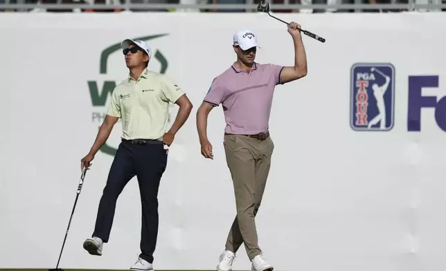 Thomas Detry, right, of Belgium, and Michael Kim, left, react to Detry's missed birdie putt on the 16th hole during the third round of the Phoenix Open golf tournament at TPC Scottsdale Saturday, Feb. 8, 2025, in Scottsdale, Ariz. (AP Photo/Ross D. Franklin)