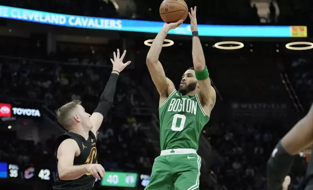 Boston Celtics forward Jayson Tatum (0) shoots over Cleveland Cavaliers guard Sam Merrill, left, in the second half of an NBA basketball game, Tuesday, Feb. 4, 2025, in Cleveland. (AP Photo/Sue Ogrocki)