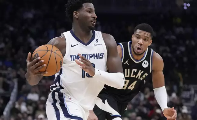 Memphis Grizzlies' Jaren Jackson Jr. drives past Milwaukee Bucks' Giannis Antetokounmpo during the second half of an NBA basketball game Sunday, Feb. 2, 2025, in Milwaukee. (AP Photo/Morry Gash)