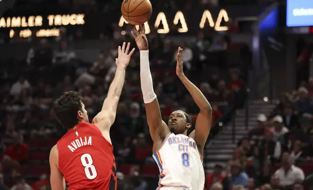 Oklahoma City Thunder forward Jalen Williams (8) shoots over Portland Trail Blazers forward Deni Avdija (8) during the first half of an NBA basketball game, Sunday, Jan. 26, 2025, in Portland, Ore. (AP Photo/Amanda Loman)
