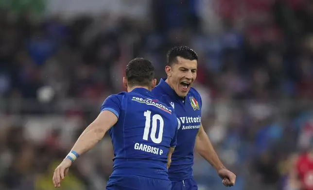 Italy's Tommaso Allan, right, celebrates with teammate Paolo Garbisi after he scored a penalty during the Six Nations rugby union match between Italy and Wales at the Olympic Stadium in Roma, Italy, Saturday, Feb. 8, 2025. (AP Photo/Alessandra Tarantino)