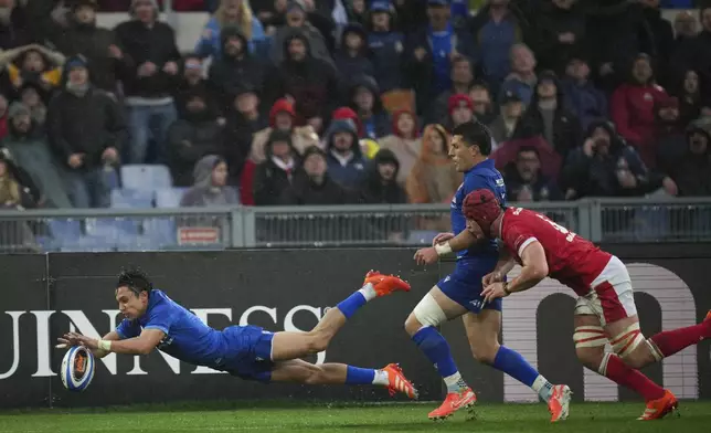Italy's Ange Capuozzo scores a try during the Six Nations rugby union match between Italy and Wales at the Olympic Stadium in Roma, Italy, Saturday, Feb. 8, 2025. (AP Photo/Alessandra Tarantino)
