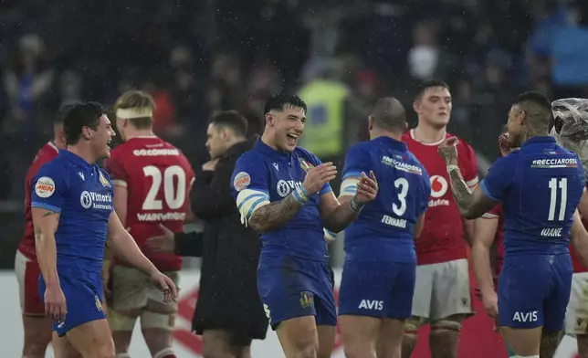 Italy's players celebrate at the end of the Six Nations rugby union match between Italy and Wales at the Olympic Stadium in Roma, Italy, Saturday, Feb. 8, 2025. (AP Photo/Alessandra Tarantino)