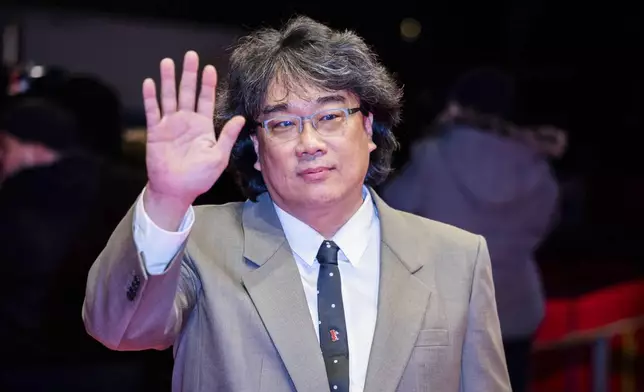 Director Bong Joon-ho poses for the photographers as he arrives for the screening of the film 'Mickey 17' at the International Film Festival, Berlinale, in Berlin, Saturday, Feb. 15, 2025. (Christoph Soeder/dpa via AP)