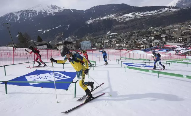 Athletes compete during the women's sprint race at the Ski Mountaineering World Cup event in Bormio, Italy, Saturday, Feb. 22, 2025. (AP Photo/Antonio Calanni)