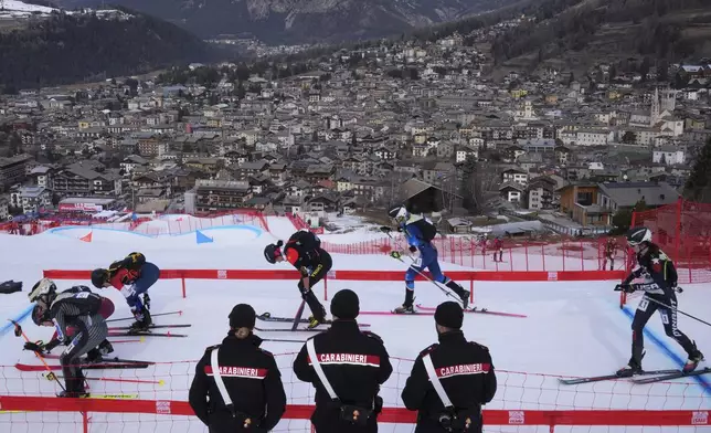 Athletes compete during the women's mixed relay race at the Ski Mountaineering World Cup event in Bormio, Italy, Sunday, Feb. 23, 2025. (AP Photo/Antonio Calanni)