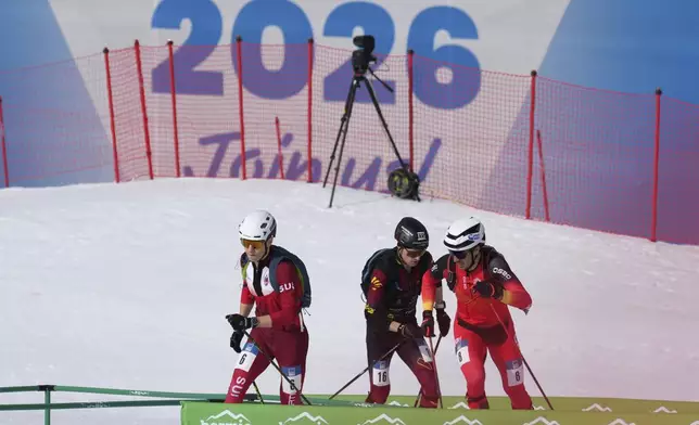 Athletes compete during the men's sprint race at the Ski Mountaineering World Cup event in Bormio, Italy, Saturday, Feb. 22, 2025. (AP Photo/Antonio Calanni)