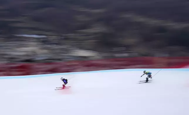 Athletes compete during the women's sprint race at the Ski Mountaineering World Cup event in Bormio, Italy, Saturday, Feb. 22, 2025. (AP Photo/Antonio Calanni)