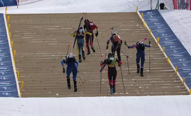 Athletes compete during the women's sprint race at the Ski Mountaineering World Cup event in Bormio, Italy, Saturday, Feb. 22, 2025. (AP Photo/Antonio Calanni)