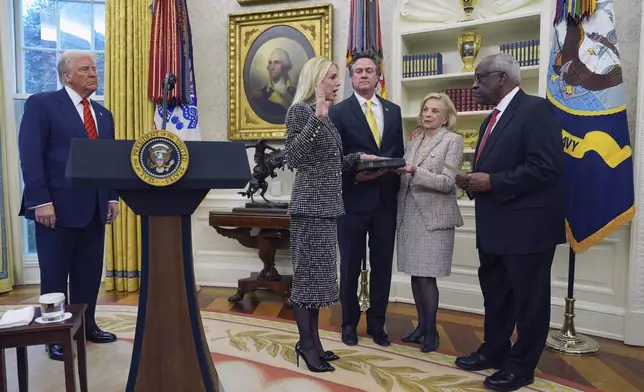 Pam Bondi is sworn in as Attorney General by Supreme Court Associate Justice Clarence Thomas, right, as President Donald Trump, partner John Wakefield and mother Patsy Bondi, look on, in the Oval Office of the White House, Wednesday, Feb. 5, 2025, in Washington. (AP Photo/Evan Vucci)