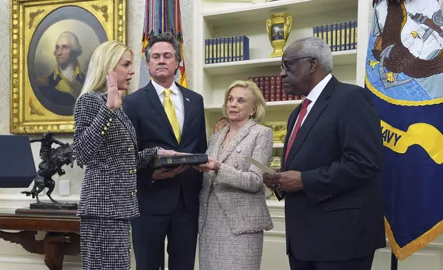 Pam Bondi is sworn in as Attorney General by Supreme Court Associate Justice Clarence Thomas, right, as partner John Wakefield and mother Patsy Bondi, look on, in the Oval Office of the White House, Wednesday, Feb. 5, 2025, in Washington. (AP Photo/Evan Vucci)