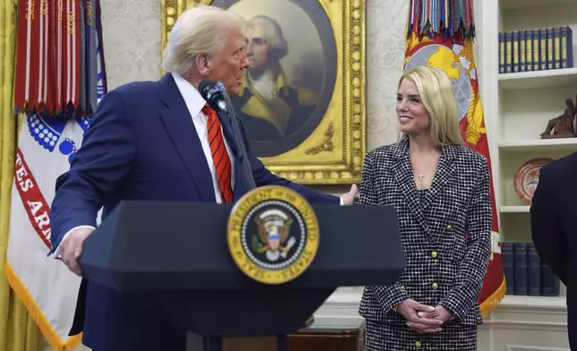 President Donald Trump welcomes Pam Bondi before she is sworn in as Attorney General by Supreme Court Associate Justice Clarence Thomas, in the Oval Office of the White House, Wednesday, Feb. 5, 2025, in Washington. (AP Photo/Evan Vucci)