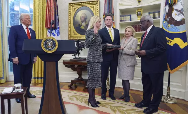 Pam Bondi is sworn in as Attorney General by Supreme Court Associate Justice Clarence Thomas, right, as President Donald Trump, partner John Wakefield and mother Patsy Bondi, look on, in the Oval Office of the White House, Wednesday, Feb. 5, 2025, in Washington. (AP Photo/Evan Vucci)