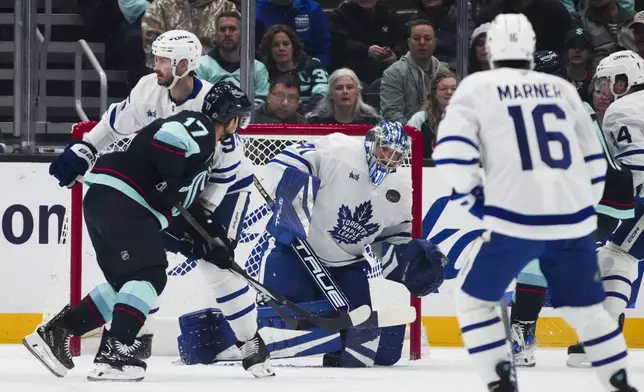 Toronto Maple Leafs goaltender Anthony Stolarz makes a save against Seattle Kraken center Jaden Schwartz (17) during the first period of an NHL hockey game Thursday, Feb. 6, 2025, in Seattle. (AP Photo/Lindsey Wasson)