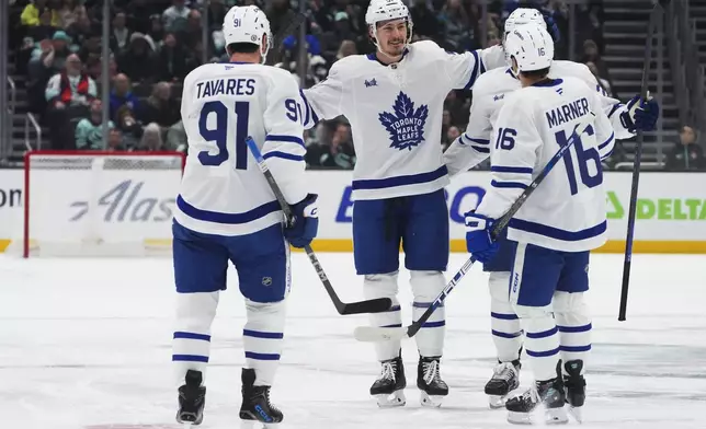Toronto Maple Leafs defenseman Philippe Myers, center facing, celebrates his goal against the Seattle Kraken with teammates, including John Tavares (91), Simon Benoit (2) and Mitch Marner (16) during the first period of an NHL hockey game Thursday, Feb. 6, 2025, in Seattle. (AP Photo/Lindsey Wasson)