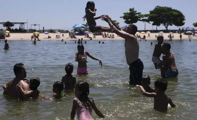 People relax at the Piscinao de Ramos artificial beach during summer in Rio de Janeiro, Sunday, Feb. 16, 2025. (AP Photo/Bruna Prado)