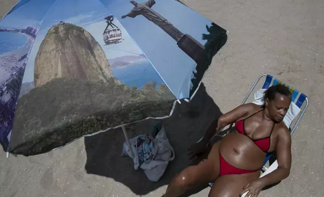 A women sunbathes at the Piscinao de Ramos artificial beach during summer in Rio de Janeiro, Sunday, Feb. 16, 2025. (AP Photo/Bruna Prado)