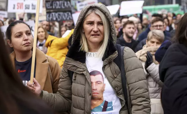 A woman wears a T -Shirt with the image of a man who died, during a protest seeking answers after last year's devastating floods and landslides in the country, in Sarajevo, Bosnia, Monday, Feb. 10, 2025. (AP Photo/Armin Durgut)