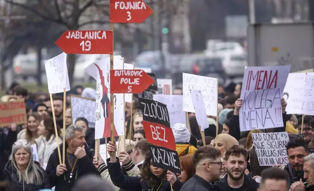 Woman holds a banner with names of cities and amount of people killed following flash floods and landslides, during a protest, in Sarajevo, Bosnia, Monday, Feb. 10, 2025. (AP Photo/Armin Durgut)
