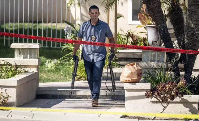 FILE - Investigators remove firearms from Judge Jeffrey Ferguson's residence in Anaheim, Calif., on Aug. 4, 2023. (Paul Bersebach/The Orange County Register via AP, File)