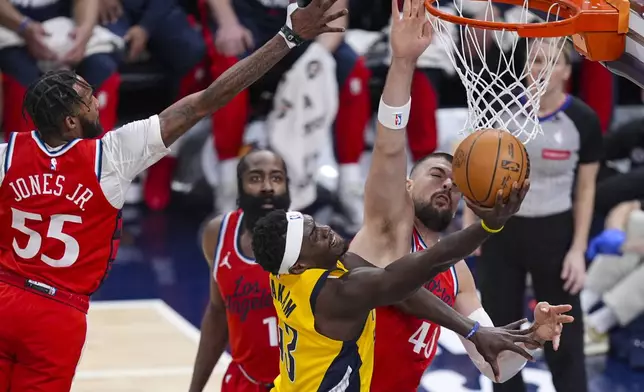 Indiana Pacers forward Pascal Siakam (43) shoots around LA Clippers center Ivica Zubac (40) during the first half of an NBA basketball game in Indianapolis, Sunday, Feb. 23, 2025. (AP Photo/Michael Conroy)