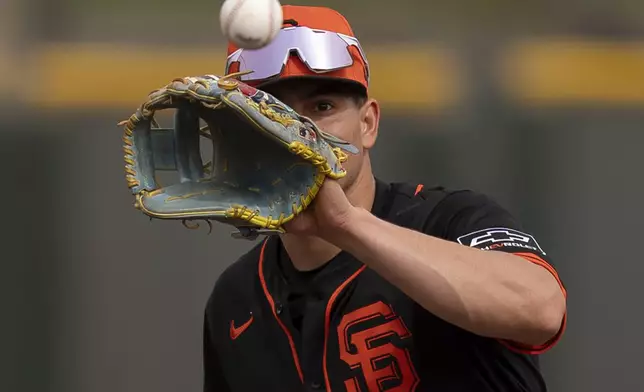San Francisco Giants shortstop Willy Adames catches a ball during spring training baseball practice at the team's training facility, Monday, Feb. 17, 2025, in Scottsdale, Ariz. (AP Photo/Carolyn Kaster)