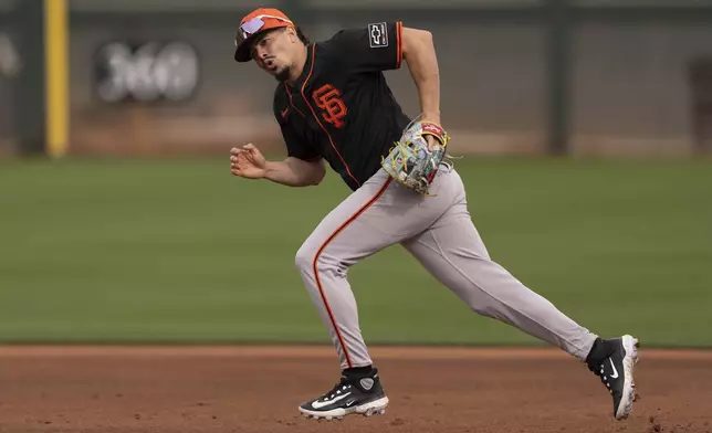 San Francisco Giants shortstop Willy Adames runs to cover third base during spring training baseball practice at the team's training facility, Monday, Feb. 17, 2025, in Scottsdale, Ariz. (AP Photo/Carolyn Kaster)
