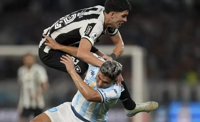 Jair of Brazil's Botafogo falls over Maximiliano Salas of Argentina's Racing Club during the second leg of the Recopa Sudamericana final soccer match in Rio de Janeiro, Thursday, Feb. 27, 2025. (AP Photo/Silvia Izquierdo)