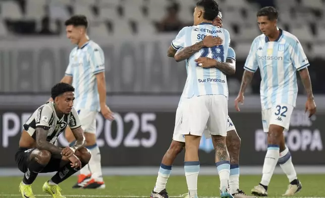 Matias Zaracho, center, and Santiago Solari (28) of Argentina's Racing Club embrace after winning the Recopa Sudamericana final soccer match against Brazil's Botafogo in Rio de Janeiro, Thursday, Feb. 27, 2025. (AP Photo/Silvia Izquierdo)