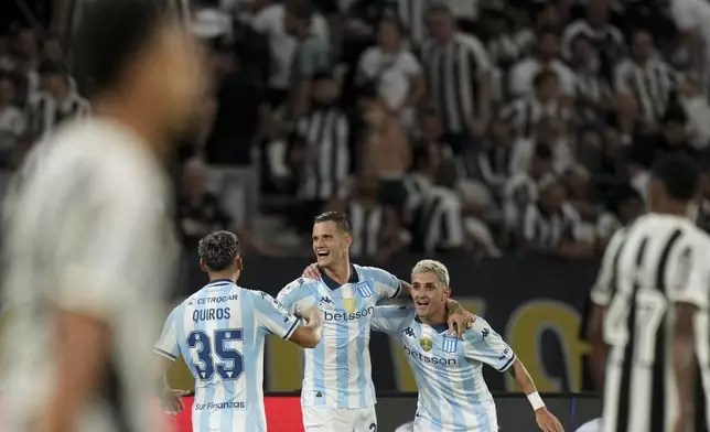 Bruno Zuculini of Argentina's Racing Club, center, celebrates scoring his side's second goal against Brazil's Botafogo with teammates Gaston Martirena, right, and Santiago Quiros during the second leg of the Recopa Sudamericana final soccer match in Rio de Janeiro, Thursday, Feb. 27, 2025. (AP Photo/Silvia Izquierdo)