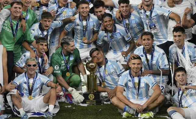 Players of Argentina's Racing Club celebrate with the Recopa Sudamericana trophy after beating Brazil's Botafogo in the final soccer match, in Rio de Janeiro, Thursday, Feb. 27, 2025.(AP Photo/Silvia Izquierdo)