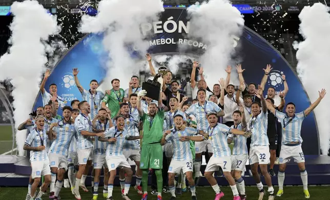 Players of Argentina's Racing Club celebrate with the Recopa Sudamericana trophy after beating Brazil's Botafogo in the final soccer match, in Rio de Janeiro, Thursday, Feb. 27, 2025. (AP Photo/Silvia Izquierdo)