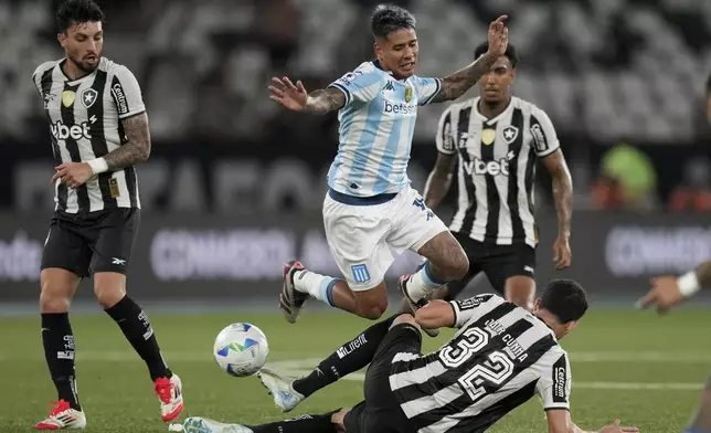 Matias Zaracho of Argentina's Racing Club falls over Jair of Brazil's Botafogo battle for the ball during the second leg of the Recopa Sudamericana final soccer match in Rio de Janeiro, Thursday, Feb. 27, 2025. (AP Photo/Silvia Izquierdo)