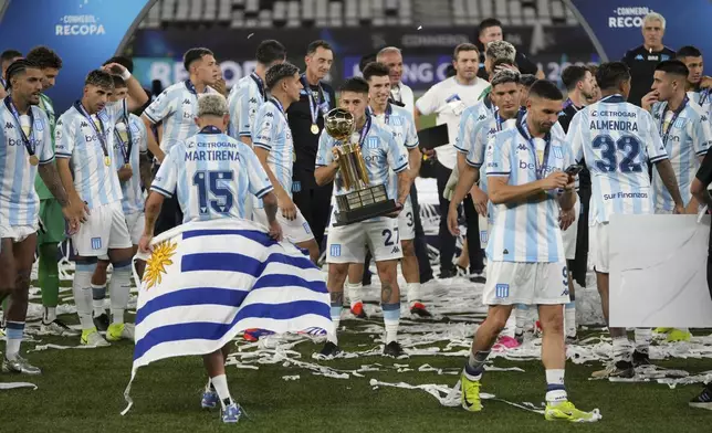 Gabriel Rojas of Argentina's Racing Club celebrates with the Recopa Sudamericana trophy after beating Brazil's Botafogo in the final soccer match, in Rio de Janeiro, Thursday, Feb. 27, 2025. (AP Photo/Silvia Izquierdo)