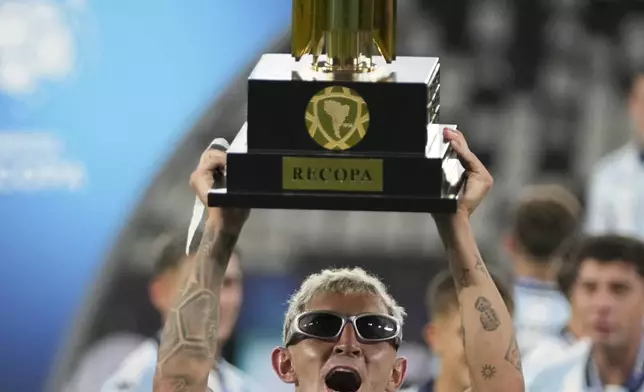 Gaston Martirena of Argentina's Racing Club celebrates with the Recopa Sudamericana trophy after beating Brazil's Botafogo in the final soccer match, in Rio de Janeiro, Thursday, Feb. 27, 2025. (AP Photo/Silvia Izquierdo)