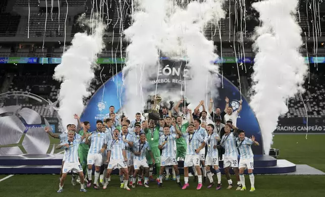 Players of Argentina's Racing Club celebrate with the Recopa Sudamericana trophy after beating Brazil's Botafogo in the final soccer match, in Rio de Janeiro, Thursday, Feb. 27, 2025. (AP Photo/Silvia Izquierdo)