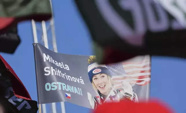 Fans from the Czech Republic wave a flag in support of United States' Mikaela Shiffrin at the finish area of a women's slalom, at the Alpine Ski World Championships, in Saalbach-Hinterglemm, Austria, Saturday, Feb. 15, 2025. (AP Photo/Giovanni Auletta)