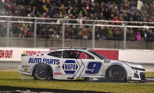 Chase Elliott does a burnout after winning a NASCAR Cup Series auto race at Bowman Gray Stadium, Sunday, Feb. 2, 2025, in Winston-Salem, N.C. (AP Photo/Matt Kelley)