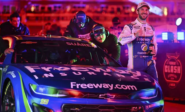 Daniel Suarez, right, and his pit crew are introduced prior to a NASCAR Cup Series auto race at Bowman Gray Stadium, Sunday, Feb. 2, 2025, in Winston-Salem, N.C. (AP Photo/Matt Kelley)