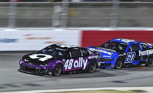 Alex Bowman (48) and Ryan Preece (60) compete into Turn 1 during a NASCAR Cup Series auto race at Bowman Gray Stadium, Sunday, Feb. 2, 2025, in Winston-Salem, N.C. (AP Photo/Matt Kelley)