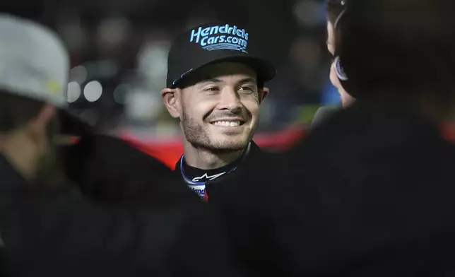 Kyle Larson smiles prior to a qualifying heat for a NASCAR Cup Series auto race at Bowman Gray Stadium, Sunday, Feb. 2, 2025, in Winston-Salem, N.C. (AP Photo/Matt Kelley)