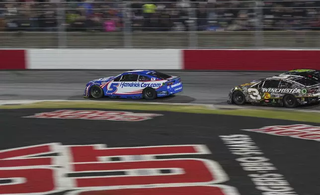 Kyle Larson (5) and Austin Dillon (3) compete through Turn 2 in a qualifying heat during a NASCAR Cup Series auto race at Bowman Gray Stadium, Sunday, Feb. 2, 2025, in Winston-Salem, N.C. (AP Photo/Matt Kelley)