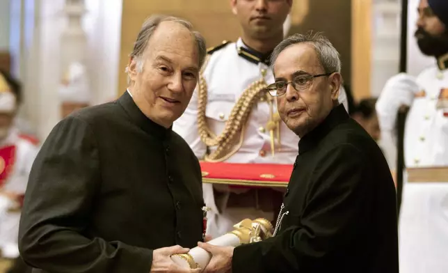 FILE - Indian President Pranab Mukherjee confers the Padma Vibhushan to the Aga Khan, spiritual head of Ismaili Muslims, left, during a civil investiture ceremony at the presidential palace in New Delhi, India, Wednesday, April 8, 2015. The Padma Vibhushan is the second highest civilian award in India. (AP Photo/Manish Swarup, File)