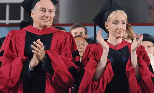 FILE - The Aga Khan, left, and author J.K. Rowling, right, clap during Harvard University commencement exercises, Thursday, June 5, 2008, in Cambridge, Mass. Both received honorary degrees during the exercises. (AP Photo/Lisa Poole, File)