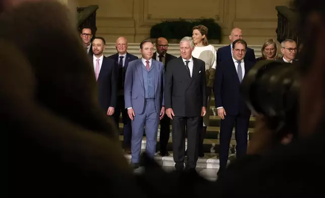 Belgium's King Philippe, center front, and new Belgian Prime Minister Bart De Wever, front center left, pose with ministers after a swearing in ceremony for the new government at the Royal Palace in Brussels, Monday, Feb. 3, 2025. (AP Photo/Omar Havana)